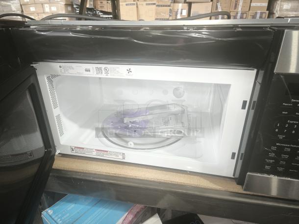 Brand new GE 1.9 Cu. Ft. over-the-range microwave oven, model JVM7195SK6SS, stainless steel, interior view.