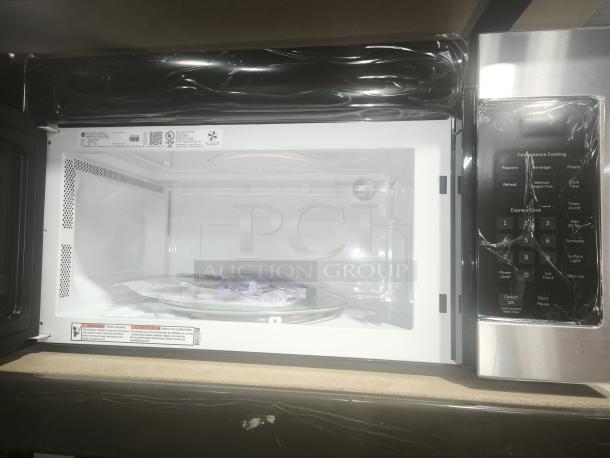 Brand new GE 1.6 Cu. Ft. over-the-range microwave, model JVM3160RF9SS, featuring a pristine interior and protective packaging.