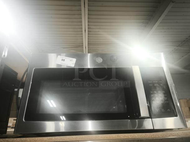 BRAND NEW GE 1.6 Cu. Ft. Over-the-Range Microwave, Model JVM3162RJ6SS, stainless steel, keypad controls, auction tag visible.