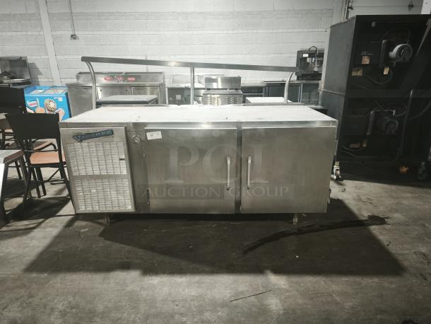 Brand new Victory URS-2S2 commercial refrigerator sandwich & salad prep table, stainless steel, dual doors, industrial setting.