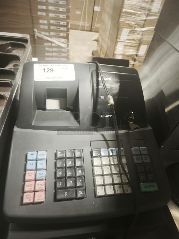Sharp XE-A22S cash register, 14x14x12 inches, in used condition. Includes multiple function keys and a display screen.