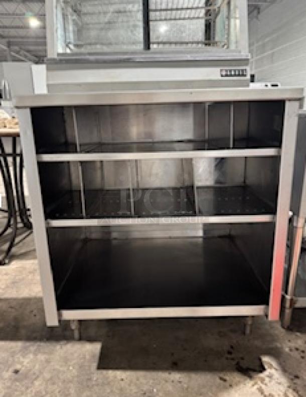 NICE CUSTOM stainless steel table by S&G Manufacturing, three open shelves, sturdy construction, ideal for commercial use.