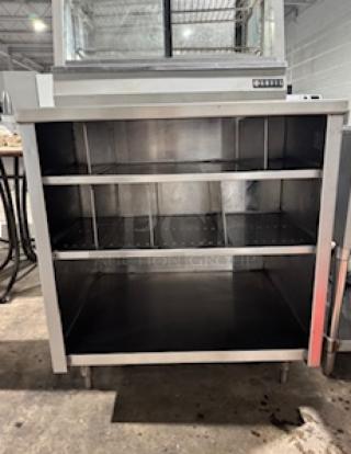 NICE CUSTOM stainless steel table by S&G Manufacturing, three open shelves, sturdy construction, ideal for commercial use.