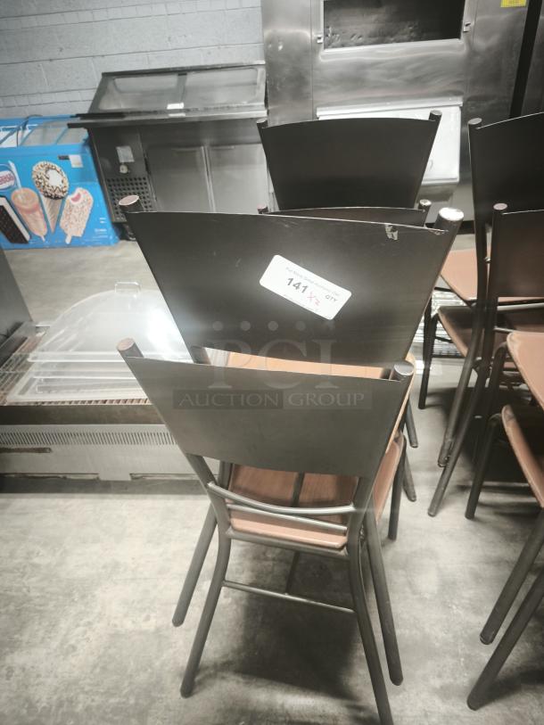 Stack of dining chairs with bronze bases, metal frames, and wooden seats. Visible label indicates quantity and lot number.