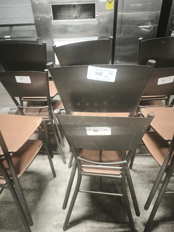 Set of dining chairs with bronze base, wood seats. Condition: Fair, visible scratches. Tags indicate auction lot numbers.