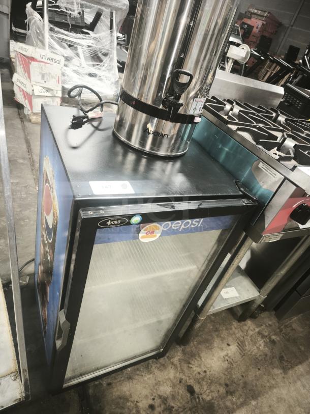 QBD Pepsi single-door glass merchandiser cooler, featuring a Pepsi logo and shelving inside. In used condition with visible surface marks.