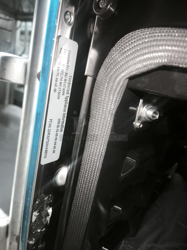 Brand new appliance with metal braided hose and appliance information label. Label includes appliance code and compliance details.