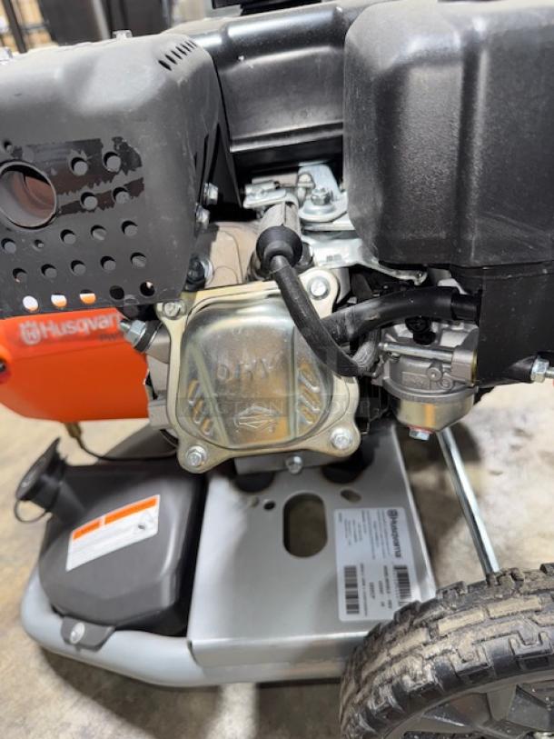 Husqvarna PW-3200 gas pressure washer, 3200 PSI, model 022007. Tested and working. Features durable metal frame and wheels.