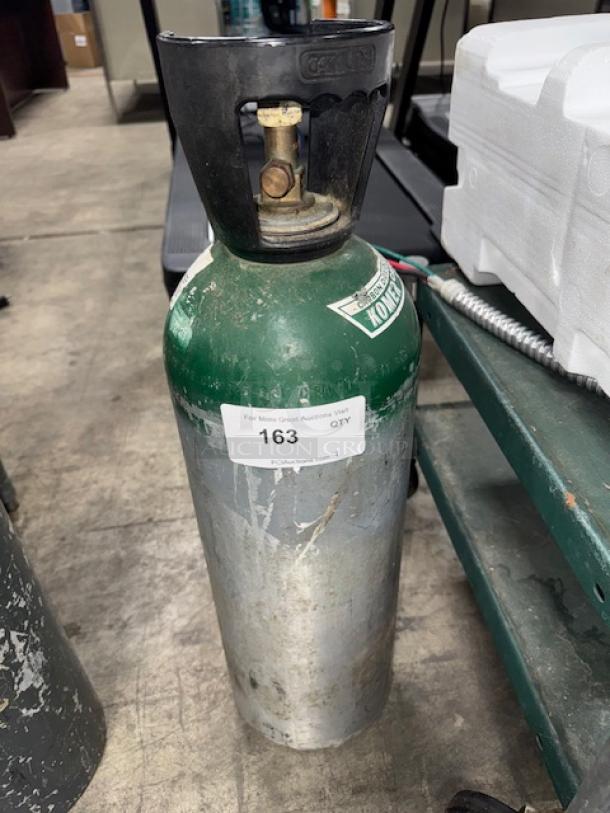 Aluminum oxygen cylinder, 60 cuft, green and silver, with valve and handle. Used condition, label showing item number 163.