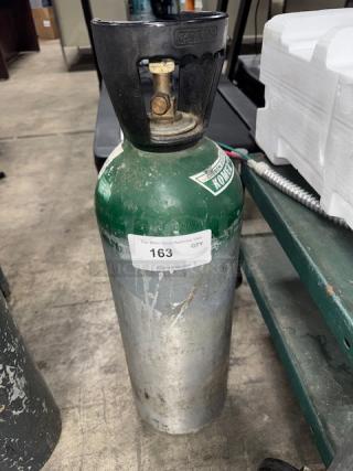Aluminum oxygen cylinder, 60 cuft, green and silver, with valve and handle. Used condition, label showing item number 163.