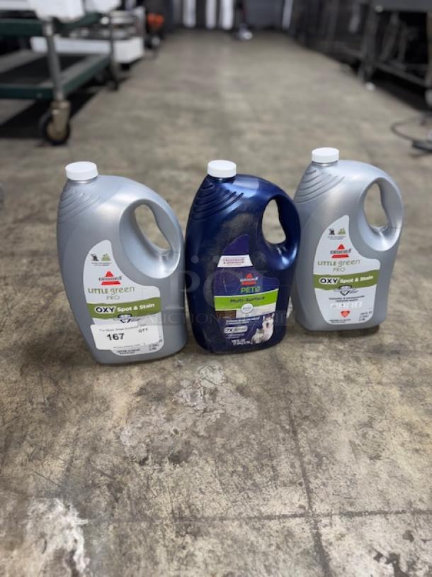 Three bottles of Bissell cleaning solutions, including Pet Pro Oxy Spot & Stain Formula, for portable carpet cleaners.