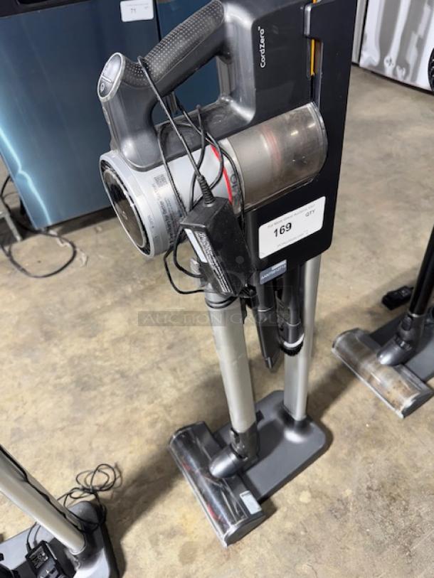 LG CordZero A9 cordless stick vacuum, tested and working. Features sleek design, modular attachments, visible tag #169.