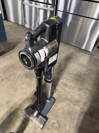 LG CordZero A9 cordless stick vacuum, tested and working, in good condition. Includes charging stand and visible label with model info.