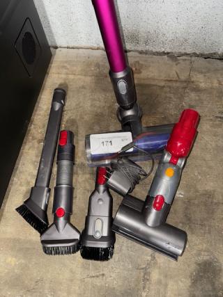 Dyson V11 Torque Drive cordless vacuum with attachments, tested and working, includes multiple cleaning tools, vibrant purple and gray design.