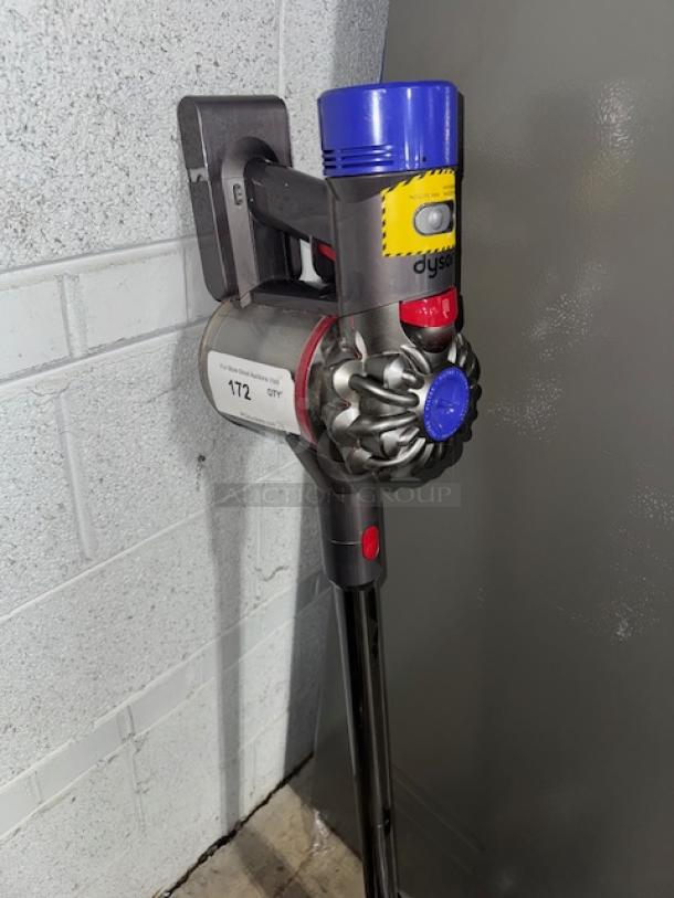 Dyson V11 Torque Drive+ Cordless Vacuum, mounted on wall, features blue and yellow accents, excellent condition.