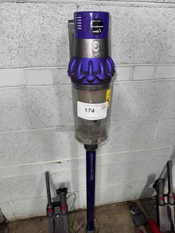 Dyson V11 Torque Drive+ cordless vacuum cleaner, blue and silver, mounted, with auction tag 174, in used condition.