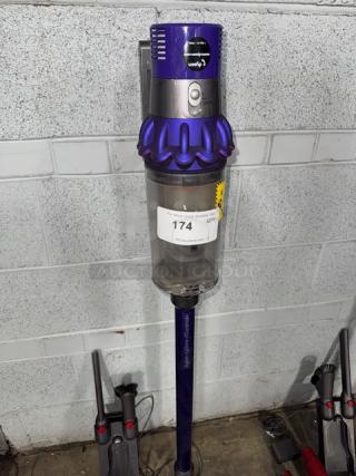 Dyson V11 Torque Drive+ cordless vacuum cleaner, blue and silver, mounted, with auction tag 174, in used condition.