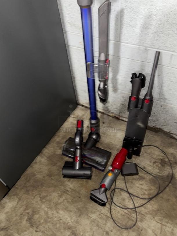 Dyson V11 Torque Drive cordless vacuum cleaner with blue wand, attachments, and charger, in used condition.