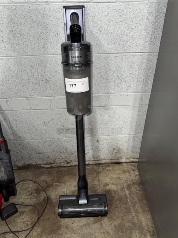 SAMSUNG cordless vacuum cleaner, tested and working, sleek design, mounted on a wall. Model tag reads "177 QTY."