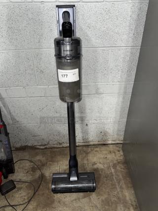 SAMSUNG cordless vacuum cleaner, tested and working, sleek design, mounted on a wall. Model tag reads "177 QTY."
