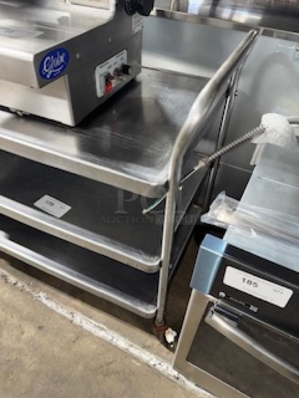Stainless steel service cart with three shelves, measuring 31 x 19 x 33 inches, in used condition.