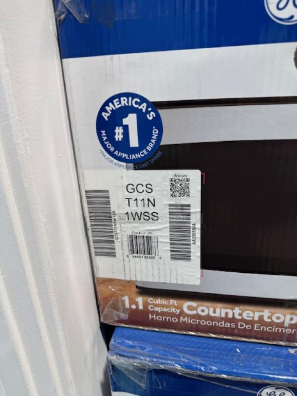Brand new GE 2.2-cu ft 1100-Watt countertop microwave in stainless steel, model GCSH22U1WSS, with packaging labels.