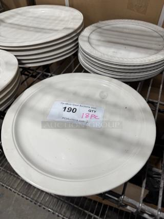 18-piece bright white stoneware plates with wide rim and rolled edge. Slightly used, auction label indicates quantity.