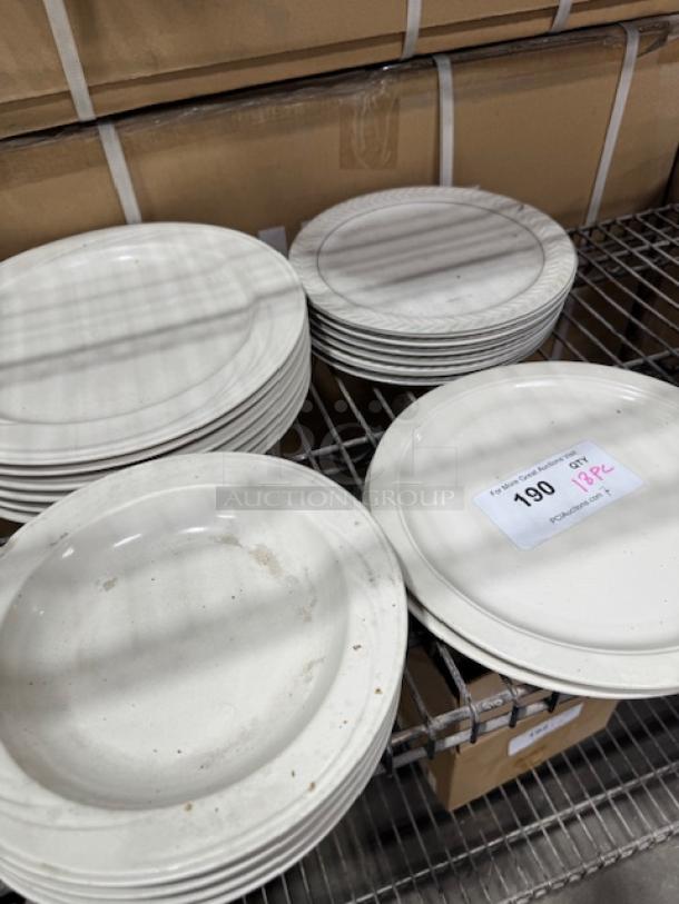 18-piece stoneware plate set, bright white, wide rim, rolled edge design. Slight wear, set includes mixed styles.