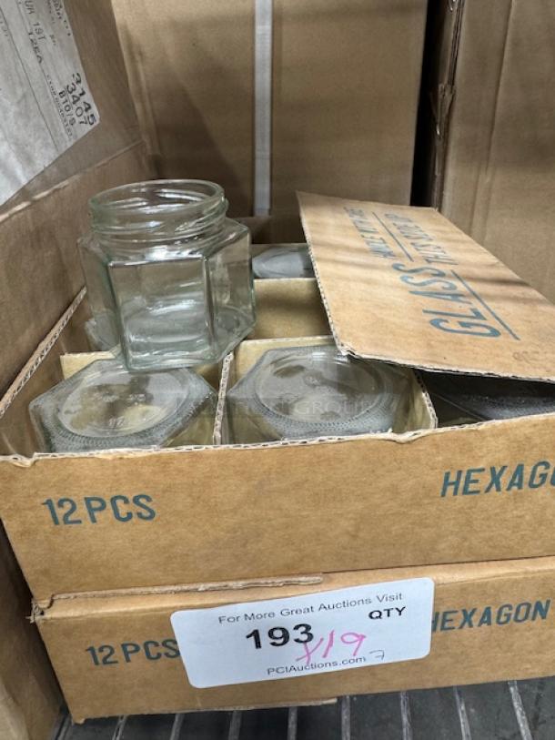 New 1.5 oz hexagon jars in a set of 12, clear glass, packaged in a cardboard box marked "HEXAGON."