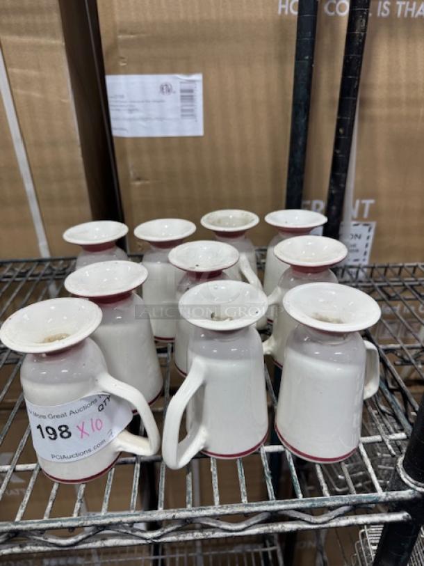 Homer Laughlin mugs with red stripes, set of 10. White ceramic, upside down on metal shelf, good condition. Auction tag visible.
