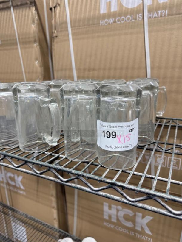 Vintage clear glass mugs on a metal shelf, in good condition. Auction tag indicates lot number 199.