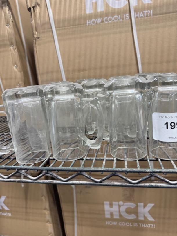 Vintage clear glass mugs on a metal shelf, featuring hexagonal bases and sturdy handles. Condition appears excellent.