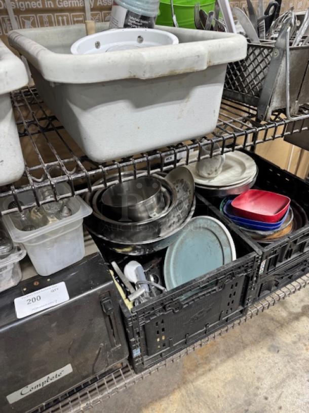 Shelf with assorted kitchenware, including bowls, plates, and containers. Some items show wear. Sold as a lot, one price.