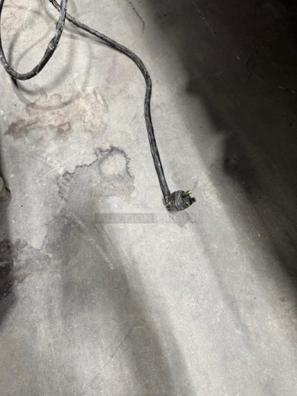 Alt text: Worn electrical cord on concrete floor, possibly associated with Fastron EM-99 SMS Deep Fryer Gas.