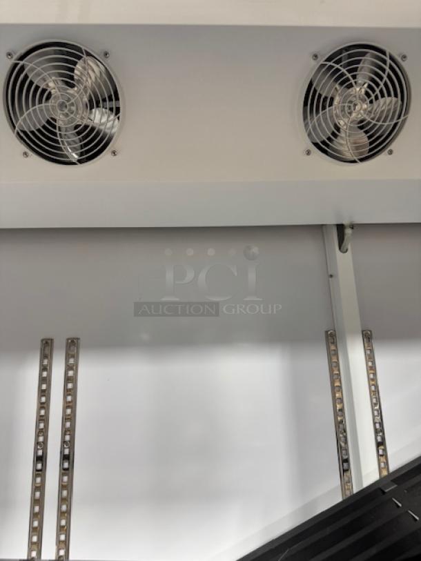 Avantco GDC-69-HC refrigerator interior view with LED lighting. Features cooling fans and shelf tracks. Needs doors. Model 178gdc69hcb.