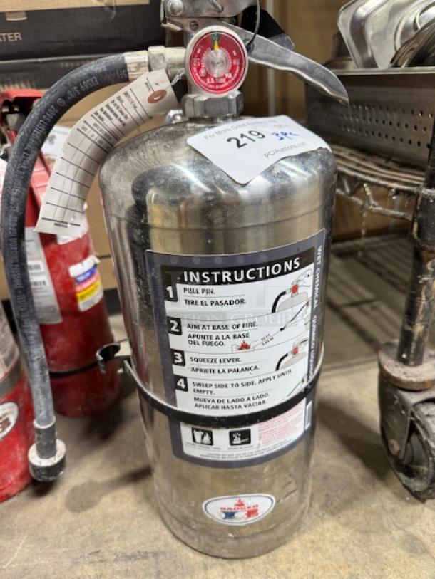Class ABC fire extinguisher set, stainless steel, includes three pieces. Visible instructions and condition appear used but well-maintained.