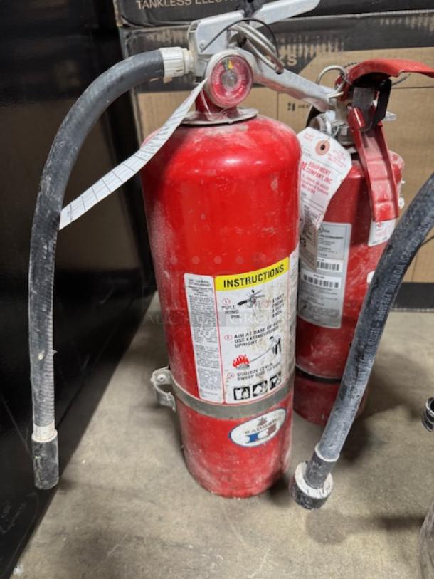 Three Class ABC fire extinguishers in red casing, visible wear, instruction labels intact, bundled for one price.