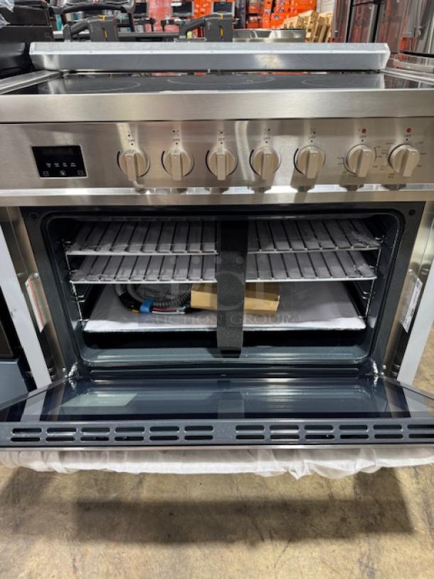 Brand new KoolMore 36-inch electric range, model KM-FR36EE-SS. Features stainless steel finish and multiple controls.