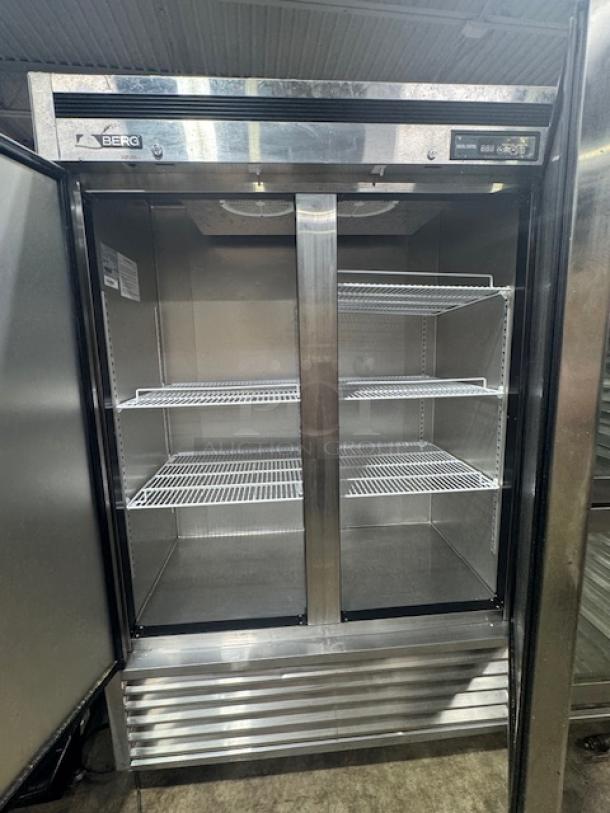 BERG BRG-F49 solid-door commercial freezer in like-new condition, featuring multiple wire shelves, stainless steel exterior.