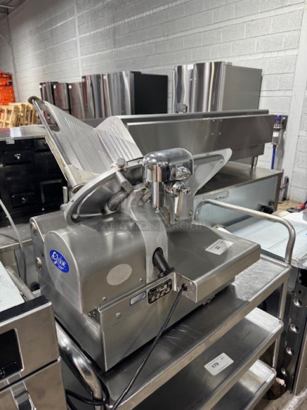 Globe 3875V 12" commercial meat slicer in good condition, stainless steel, tested and working, with power cord.