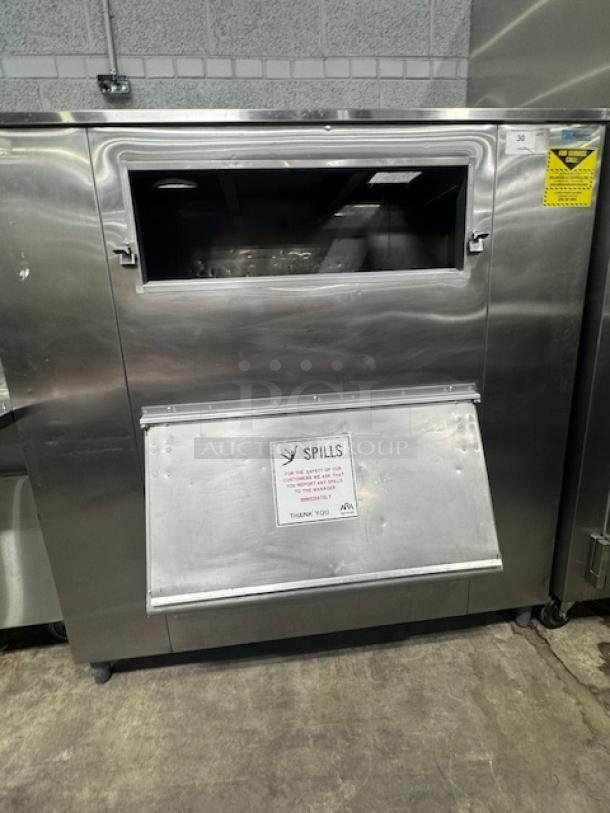 MGR Equipment SP-1650-SS ice storage bin, stainless steel, front-loading, visible safety labels, good condition.