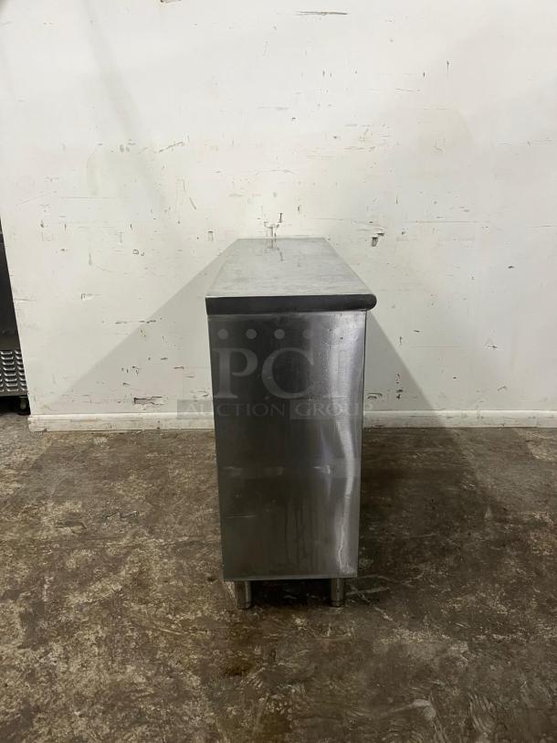 YUKON stainless steel cabinet, open front, sturdy condition, suitable for storage, features a polished finish and durable legs.