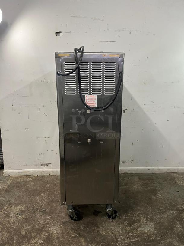 TAYLOR 794-33 soft serve ice cream machine, stainless steel, on casters, visible power cord, fair condition.