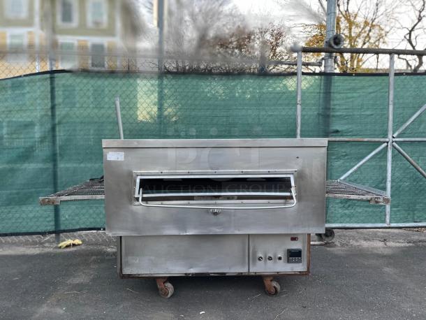 Middleby Marshall PS360G gas conveyor oven, used, stainless steel, known for high-volume rapid cooking, on wheels.