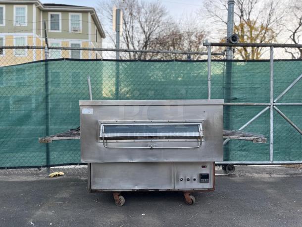 THE MIDDLEBY MARSHALL PS360G oven, commercial-grade gas-fired impingement conveyor, stainless steel, outdoor setting, good condition.