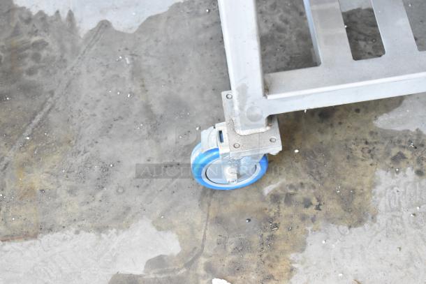 AM Manufacturing LT1800BH pizza press leg with blue caster, showing floor placement.