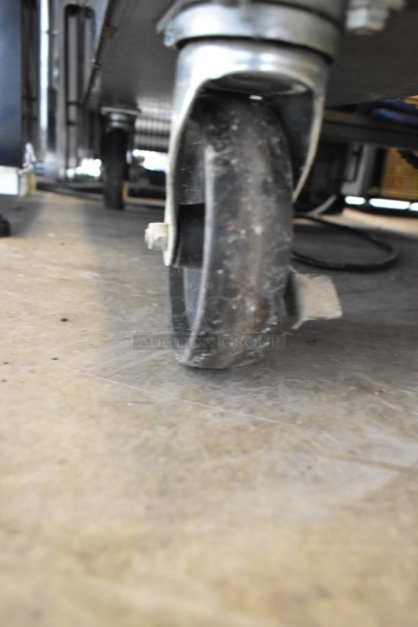 Close-up of a caster wheel from the Autofry MTI-40E stainless steel commercial ventless fryer, showing mobility feature.