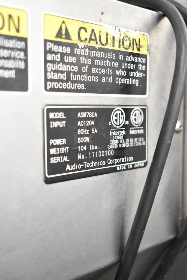 Autec Audio-Technica ASM780A sushi machine label showing model, 120V input, 500W power, weight 104 lbs, made in Japan.