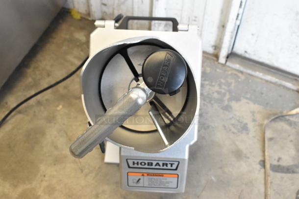 2022 Hobart FP-150 food processor, metal, continuous feed, with full moon pusher. Features visible brand name and warning label.