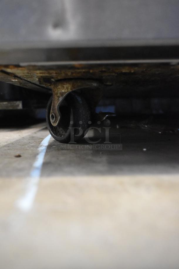 2020 Delfield 406P-STAR2 undercounter cooler wheel on commercial caster; visible rust and wear. Stainless steel, 115V.